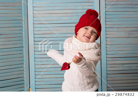 playful baby in bright red hat blue background playful baby in bright red hat blue background 29874832
