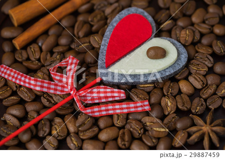 Grains of coffee close-up and decorative red heart Grains of coffee close-up and decorative red heart 29887459