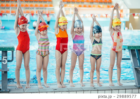 Instructor and group of children doing exercises 29889577