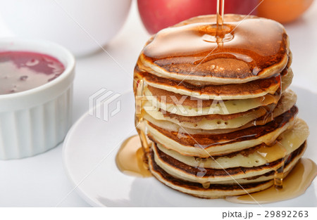 Pancakes stack pouring marple syrup 29892263