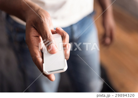 Friendly young African American showing device in Friendly young African American showing device in 29894320