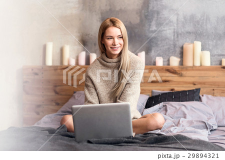 Delighted young woman using laptop at home Delighted young woman using laptop at home 29894321