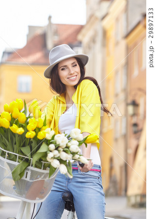 sensual brunette girl sitting on bicycle with some spring flower sensual brunette girl sitting on bicycle with some spring flower 29897133