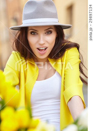 sensual brunette girl sitting on bicycle with some spring flower sensual brunette girl sitting on bicycle with some spring flower 29897134