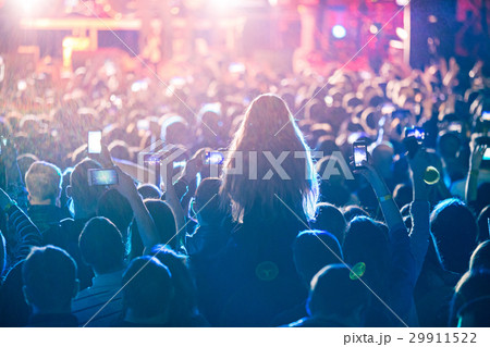 The silhouettes of concert crowd in front of 29911522