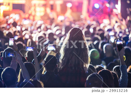 The silhouettes of concert crowd in front of The silhouettes of concert crowd in front of 29913216