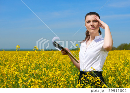 Business woman in field outdoor with cloudy sky Business woman in field outdoor with cloudy sky 29915002