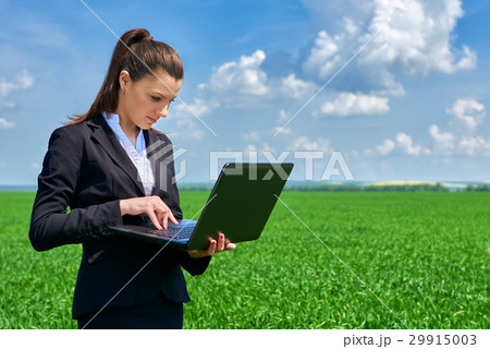 Business woman in field outdoor with cloudy sky Business woman in field outdoor with cloudy sky 29915003