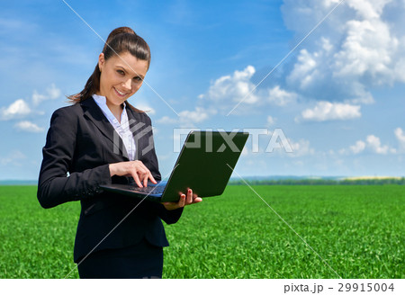 Business woman in field outdoor with cloudy sky Business woman in field outdoor with cloudy sky 29915004