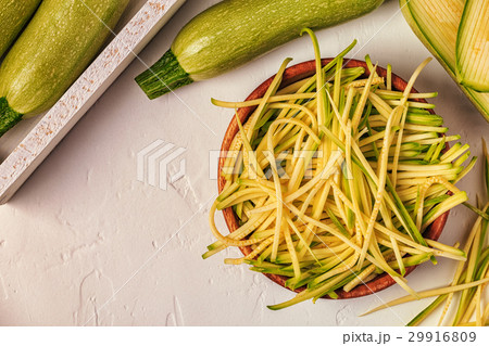 Raw zucchini pasta on white background. 29916809