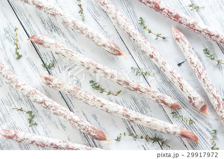 Fuet sausages on the wooden background Fuet sausages on the wooden background 29917972