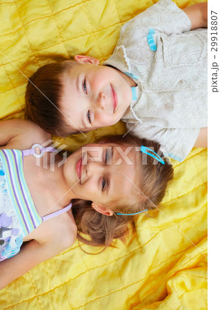 cute boy and girl lying on blanket 29918807