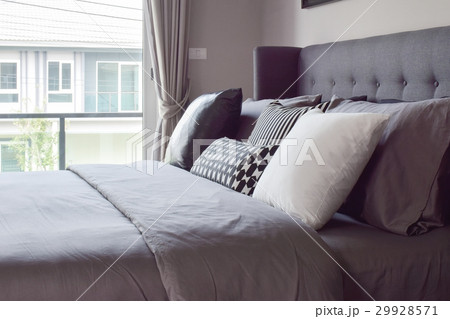 Classic bedroom with pillows next to the window Classic bedroom with pillows next to the window 29928571