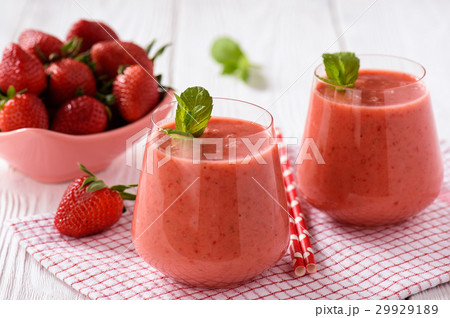 Strawberry smoothie in glass on wooden background. 29929189