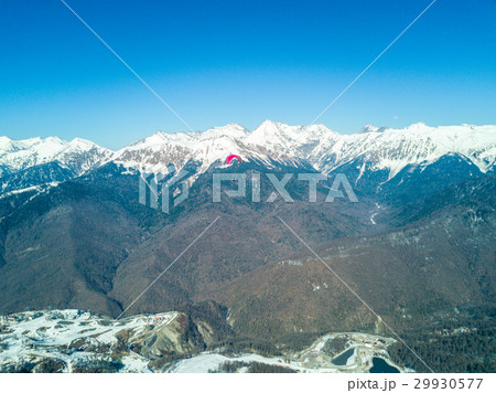 Paraglider flies over the mountains over the ski Paraglider flies over the mountains over the ski 29930577