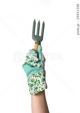 Hand in glove holding garden fork Hand in glove holding garden fork 29931396