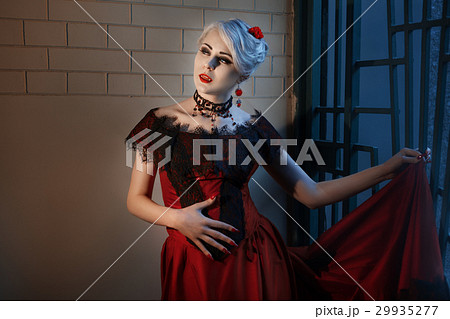 Woman with the fangs of a vampire. Woman with the fangs of a vampire. 29935277