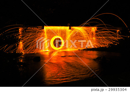Man playing fire baton in Texture background Man playing fire baton in Texture background 29935304