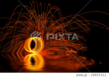 Man playing fire baton in Texture background Man playing fire baton in Texture background 29935311
