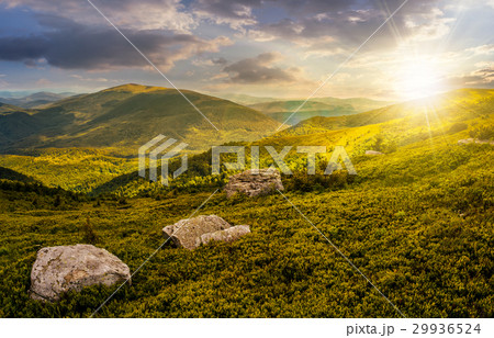 stones on the edge of mountain hillside at sunset stones on the edge of mountain hillside at sunset 29936524