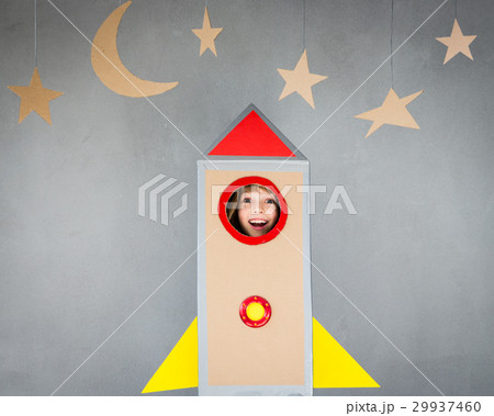 Kid playing with cardboard rocket at home Kid playing with cardboard rocket at home 29937460