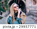 Blonde woman in sunglasses outdoors city walk 29937771