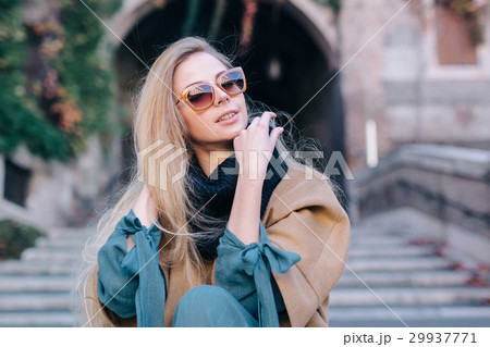 Blonde woman in sunglasses outdoors city walk 29937771