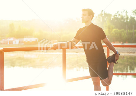 Fitness man stretching his leg before a run 29938147