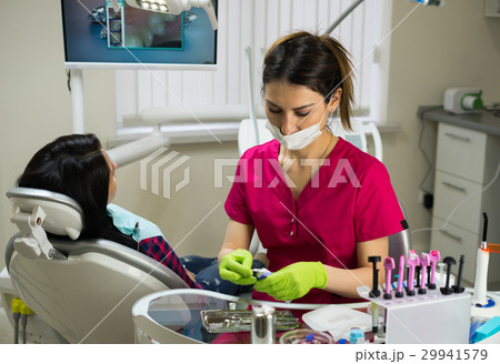 dentist at work preparing instruments dentist at work preparing instruments 29941579
