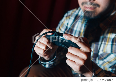 Unrecognizable guy with joystick play video game 29947807