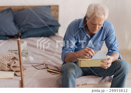Depressed sad man holding a box with mail 29953612