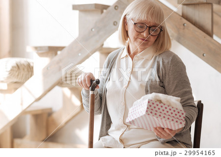 Nice depressed woman holding a gift box Nice depressed woman holding a gift box 29954165