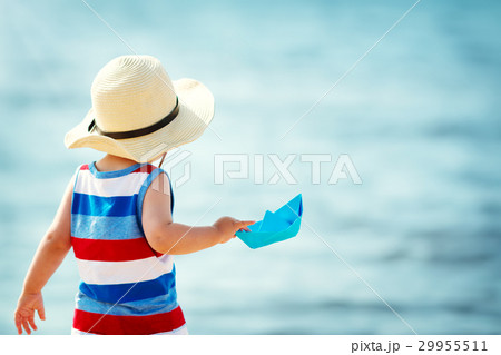 little boy playing at the beach in straw hat little boy playing at the beach in straw hat 29955511