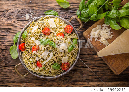 Italian spaghetti with basil pesto and tomatoes. 29960232