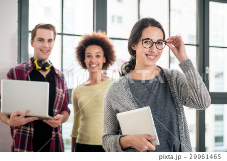 Portrait of man smiling while holding a laptop Portrait of man smiling while holding a laptop 29961465