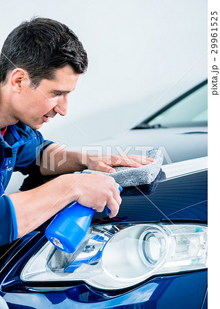 Man cleaning his car with a sponge Man cleaning his car with a sponge 29961525