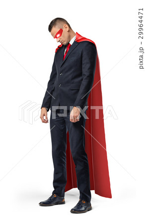 A sad businessman in a superhero red cape standing A sad businessman in a superhero red cape standing 29964471