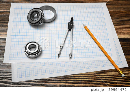 A vernier caliper holding a bearing, a pencil and 29964472