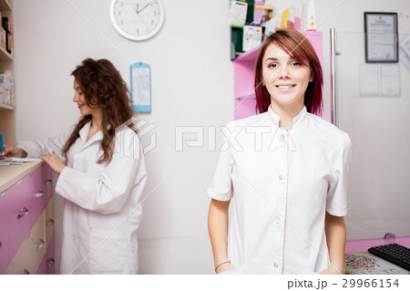 Two pharmacist woman at work place Two pharmacist woman at work place 29966154