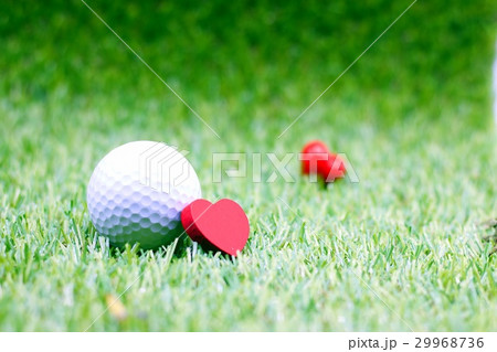 Golf ball with heart on green grass Golf ball with heart on green grass 29968736