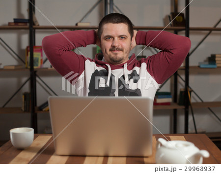 Man with laptop leans back Man with laptop leans back 29968937