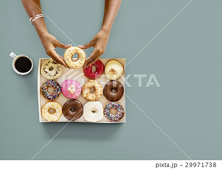 Hands holding sweeten donut dessert in aerial view Hands holding sweeten donut dessert in aerial view 29971738