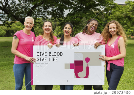 Group of women holding banner of blood donation campaign 29972430