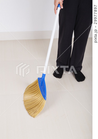woman legs with broom sweeping floor woman legs with broom sweeping floor 29977897