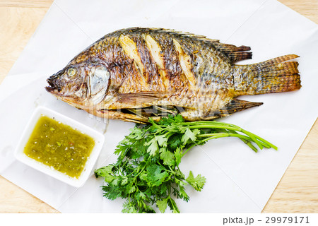 Grilled fish and spicy seafood sauce 29979171
