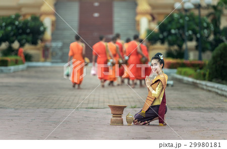 Woman give food offerings to Buddhist monks. Woman give food offerings to Buddhist monks. 29980181