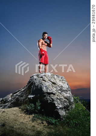 Muscular male boxer training outdoors Muscular male boxer training outdoors 29981670