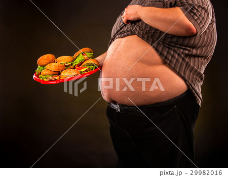 Man belly fat with hamberger fast food for 29982016