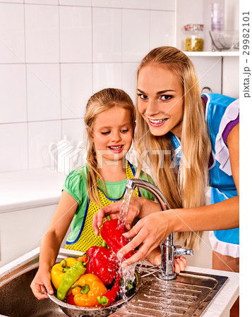 Fruit and vegetable wash of woman on kitchen home. 29982101