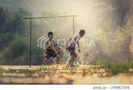 Boy kicking a soccer ball Boy kicking a soccer ball 29982506